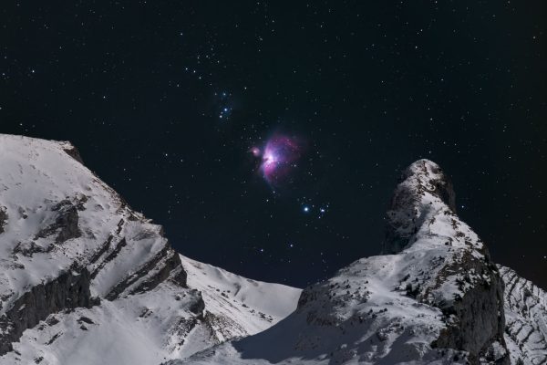 Great Orion Nebula above Snowy Mountain Peak