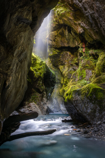Waterfall in Narrow Mossy Slot Canyon